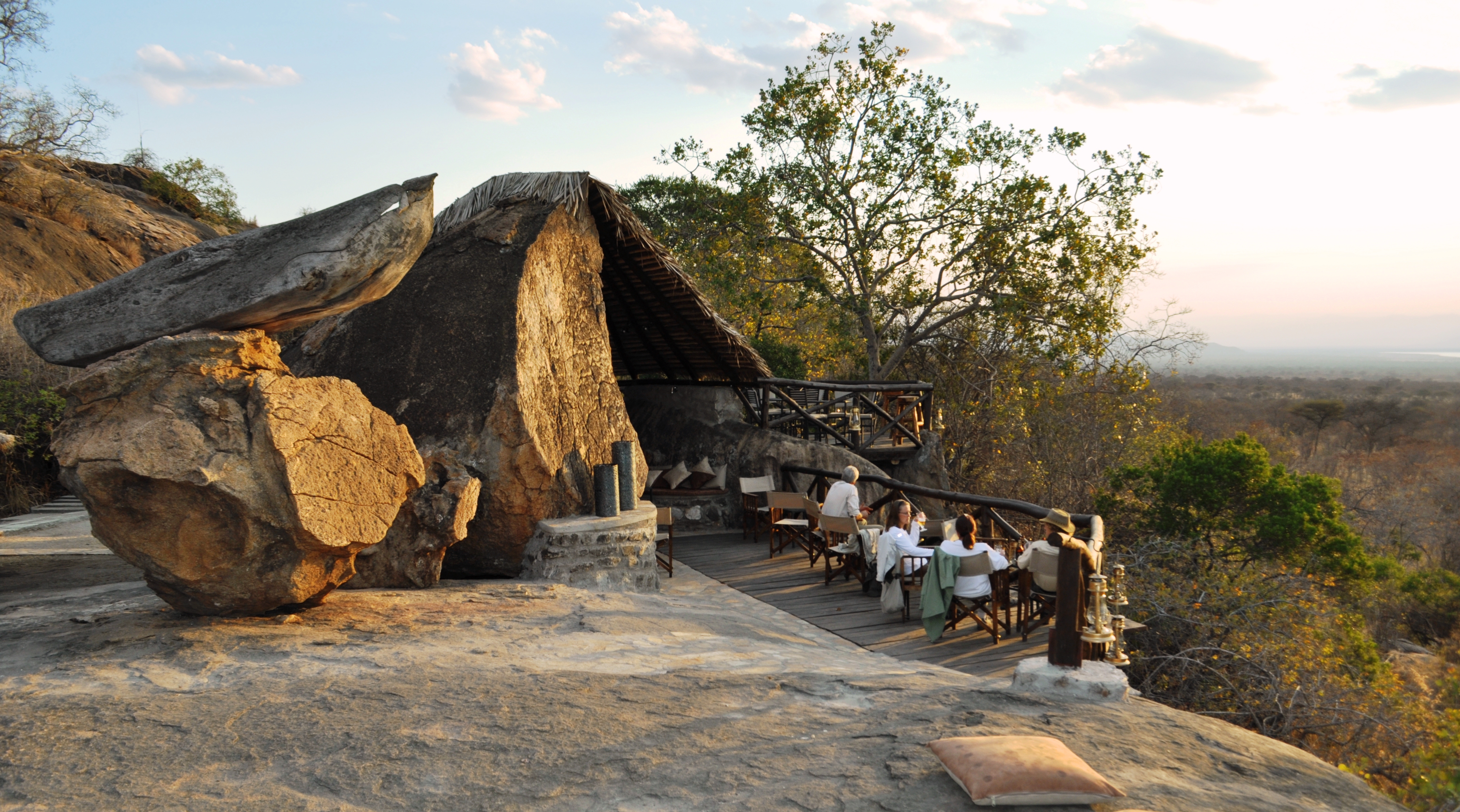 Guest enjoying a drink and the view from a rock